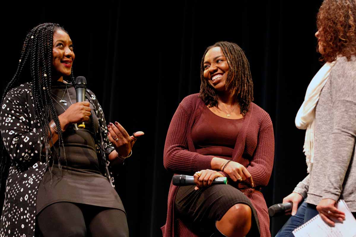 Alicia Garza, left, a co-founder of the Black Lives matter movement, laughs with Opal Tometi at the beginning of the panel discussion Thursday evening, Feb. 18, 2016. "Maybe we can get rid of the binaries o right and wrong and focus on what'll set up free," Garza said. Photo by Tanzi Propst.