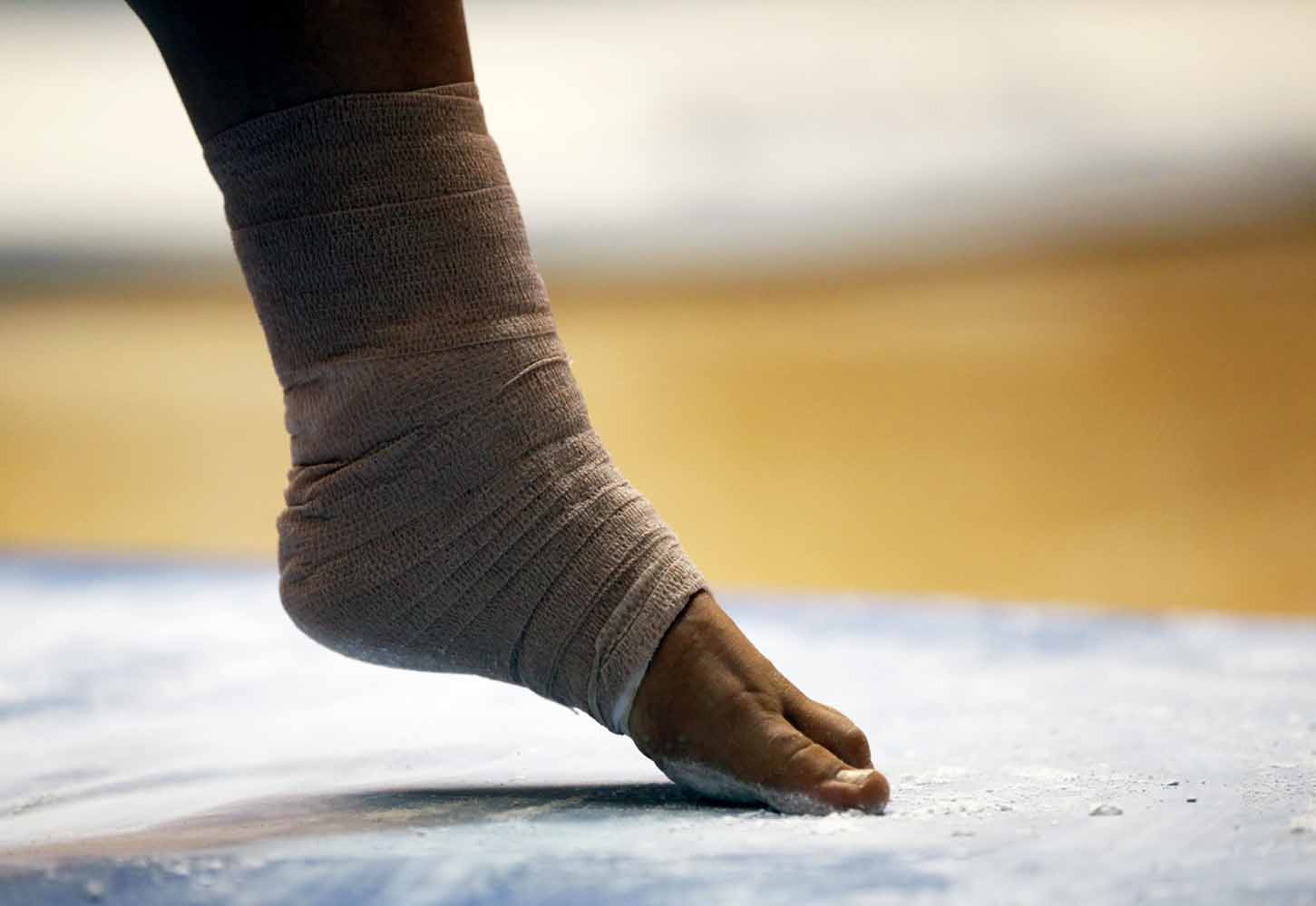 Mizzou sophomore Shauna Miller rubs her toes and the balls of her feet in chalk dust on the mat near the balance beam before her performance Friday evening, Feb. 19, 2016 in the Hearnes Center.