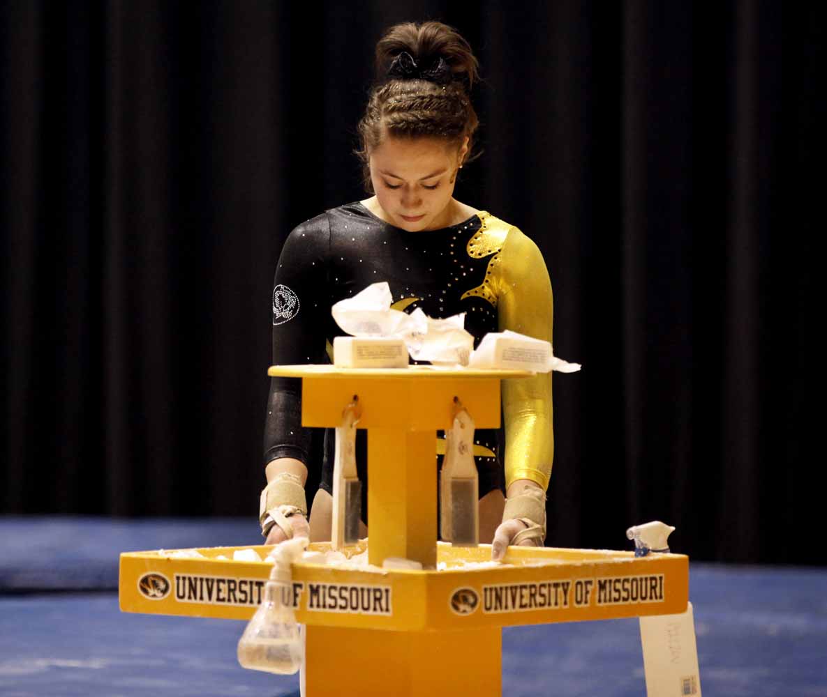 Mizzou freshman Madeleine Huber takes a moment by herself at the chalk station before heading over to the floor routine area Friday evening, Feb. 19, 2016 at the Hearnes Center.