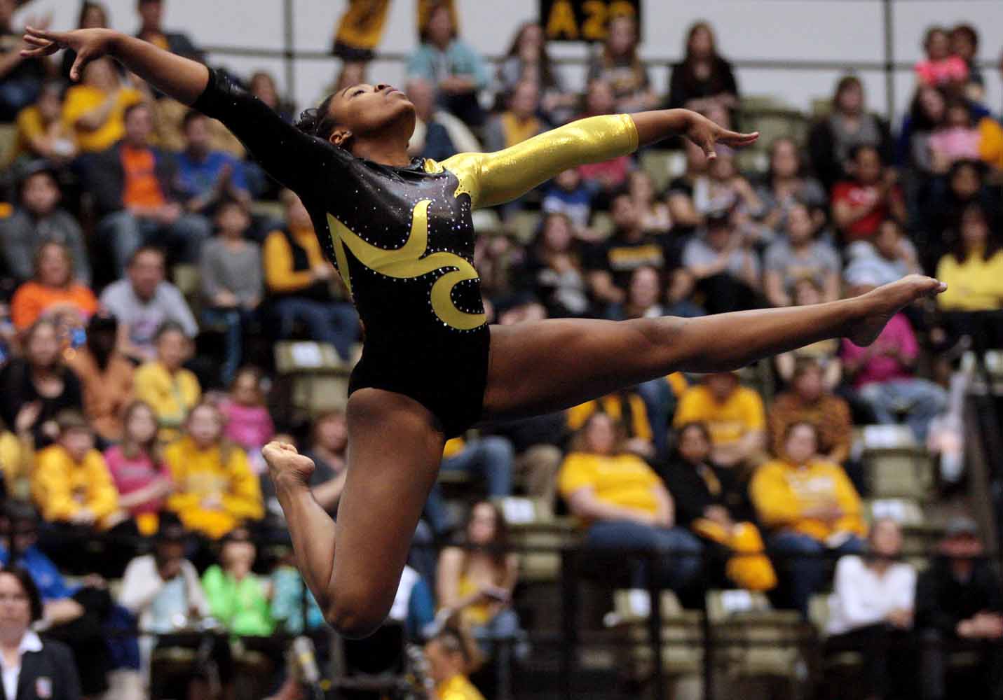 Mizzou sophomore Kennedi Harris leaps into a pose during her floor routine Friday evening, Feb. 19, 2016 at the Hearnes Center near the end of the gymnastics competition against the University of Florida.