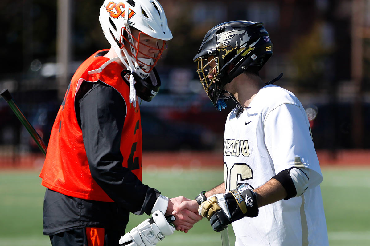 Mizzou Lacrosse Team Captain Phil Bergman (26) shakes hands with an Oklahoma State University player at the conclusion of the game on Stankowski Field Sunday, Feb. 21, 2016. Mizzou won 13-0.