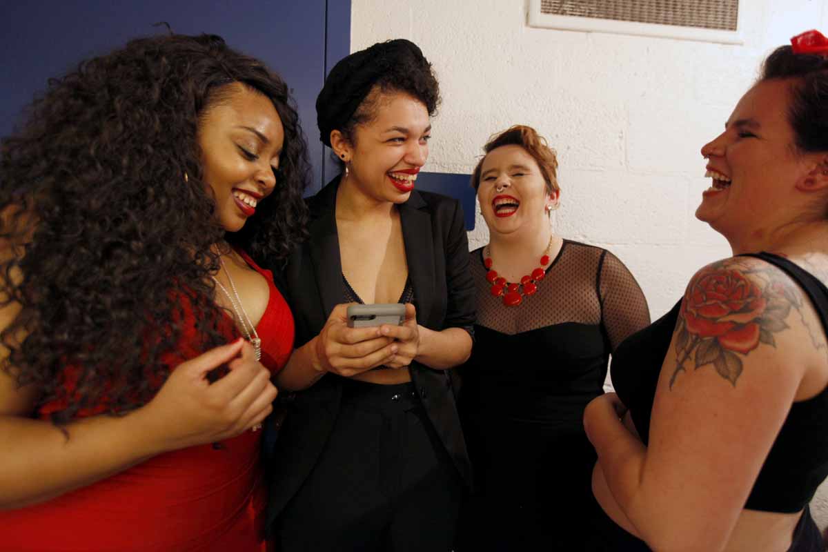 From left, KeAnn "KeKe" Mays-Lenoir, Deja Mackey, Mayme Jordan and Laura Farrington laugh at a photo on Mackey's phone prior to their performance in the Vagina Monologues, Saturday, Feb. 27, 2016. The four all performed together in a skit that closed out the first act of the show.
