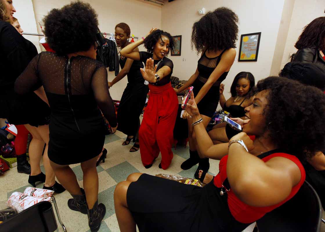Alanna Diggs, middle, dances with other actresses performing in the Vagina Monologues in one of the dressing rooms of Jesse Auditorium before the Vagina Monologues Saturday evening, Feb. 27, 2016.