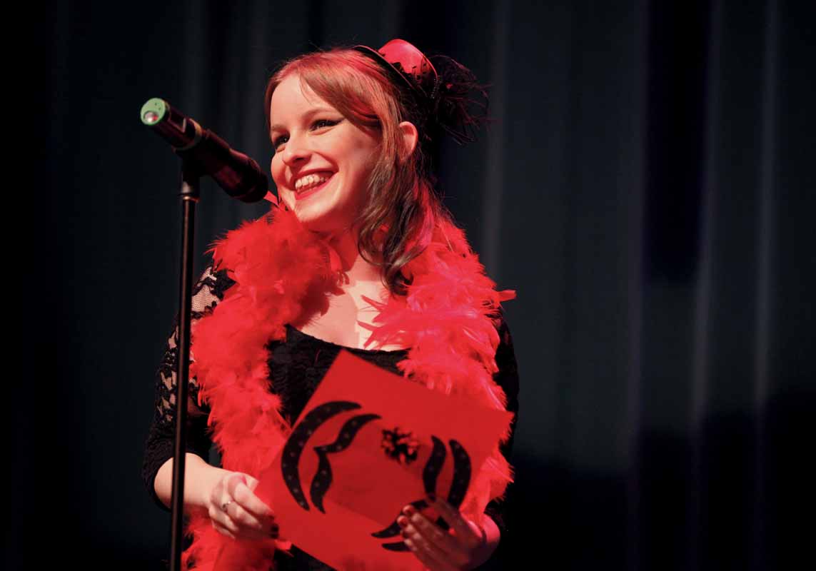 Wendy Hayworth smiles during her performance of "Vagina Happy Fact" during the Vagina Monologues Saturday evening, Feb. 27, 2016 in Jesse Auditorium.
