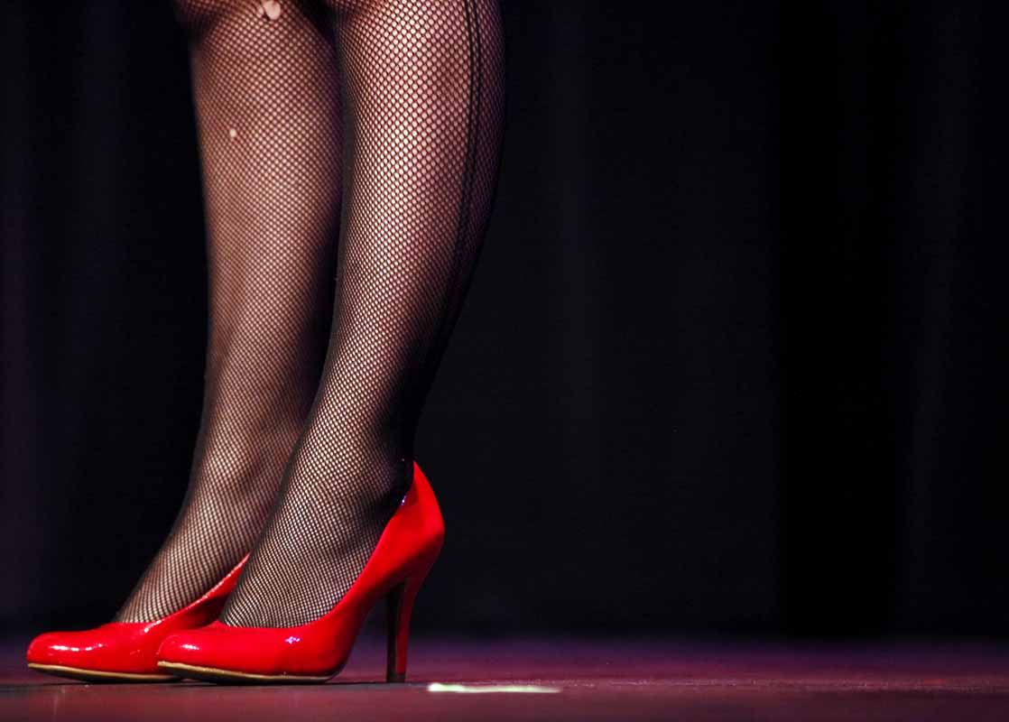Mikala Compton dons her red heels on stage during the "I Was 12, My Mother Slapped Me" skit in the Vagina Monologues Saturday evening, Feb. 27, 2016.