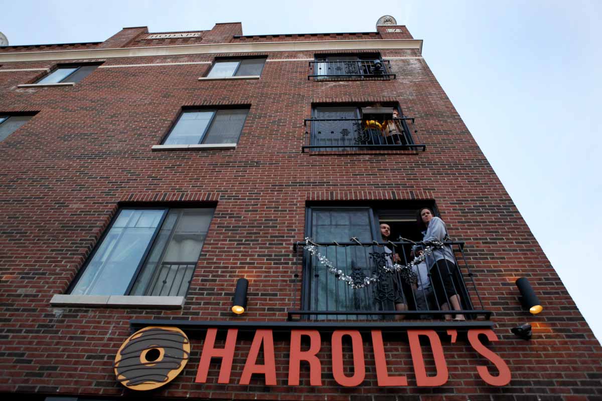 Spectators view the annual March March parade from their apartments above Harold's Donuts. Photo by Tanzi Propst.