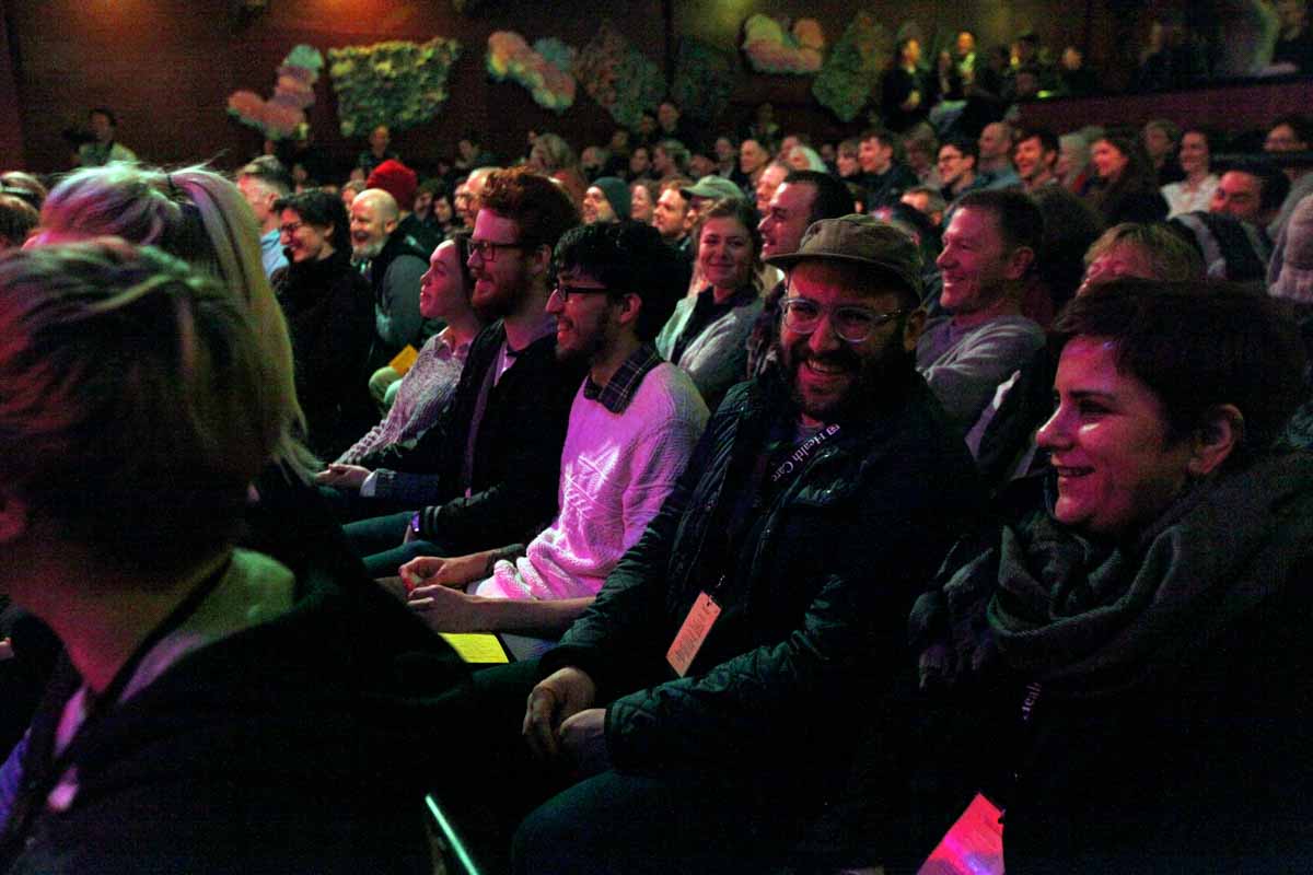 Gimme Truth! attendees laugh during host Johnny St. John's comedic dialogue at The Blue Note Saturday evening. Photo by Tanzi Propst.