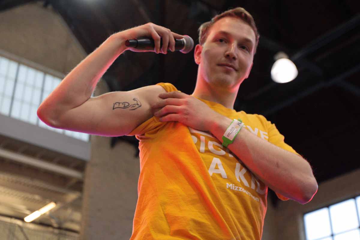 Zack Newman shows his tattoo during his speech about "Zacking" during the main event Saturday, March 12, 2016. After his friend Zachary Lederer passed away from brain cancer, Newman decided to get a tattoo in his honor. "LTD" to honor Lederer's motto "Living the Dream" and the flexed arm to mimic the pose he would make while going through treatment. "It means hope. It means positivity. It's a reminder that we're not moving in isolation and can make an impact onto one another," Newman said. "I've outlived him, but I won't let his spirit die." Newman encourages everyone to follow @ZachingVsCancer on Twitter.
