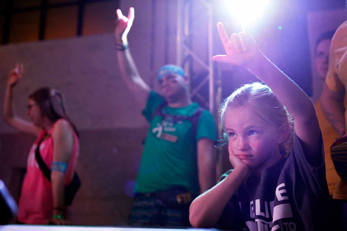 Mallory Strope, 6, holds her hand in the air with the sign language for “I love you” while Cassidy-Rae Luebbering’s mom shares their story. Strope is Miracle Child Connor Stope’s little sister.