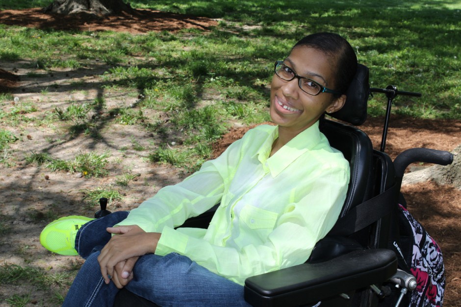 Romanda smiling in a wheelchair.