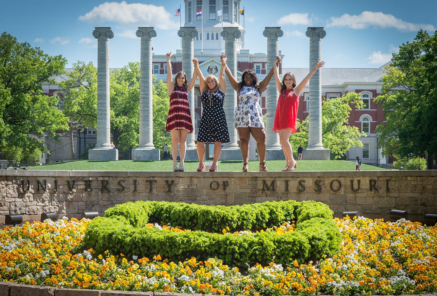 Nursing majors Shannon Williams, Rachel Starkey, Christyl Thurman and Haley Neff reach for the sky where Eighth Street intersects with the heart of campus.