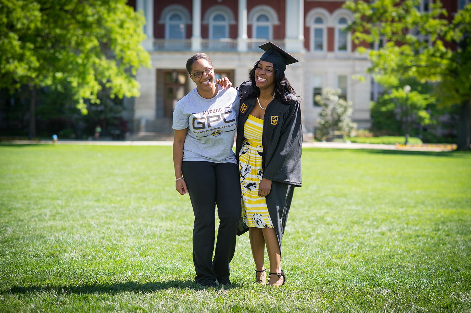 Communication major Andrea Boyd and secondary education major Tiara Williams pose for a portrait on The Quad. Williams is a first-generation college graduate who plans to teach English in her home town of Kansas City. Both young women are Alpha Kappa Alpha sisters who will be graduating next week.