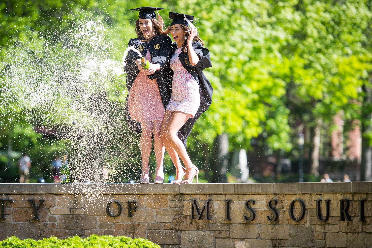 Marketing major Vanessa Salomon and mass media communication major Holly Sias celebrate their pending graduation with a bottle of sparkling bubbly.