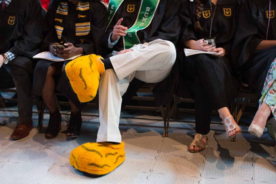 A friend of Truman's sits in the front row during commencement ceremonies. Photo by Shane Epping.