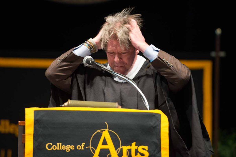 Commencement speaker Major Garrett, BA '84 political science, BJ '84, messes up his hair as part of his speech to graduates. Photo by Shane Epping.
