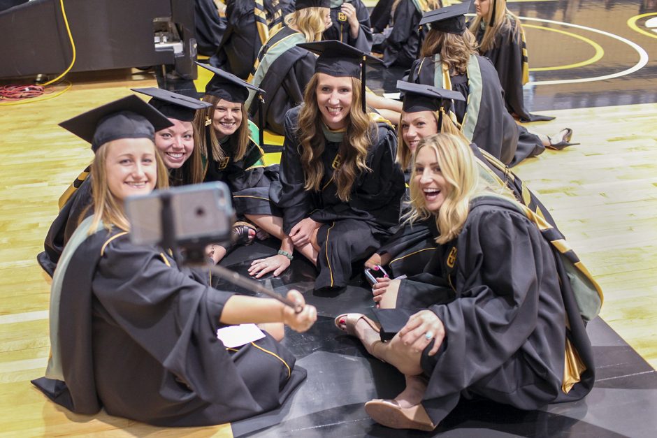 School of Health Professions graduates entertain themselves by taking a selfie before the start of the school's graduation ceremony Sunday . From left, they are Catherine Bean, Melissa Zemke, Alysia Carey, Carrie Schuebel, Kelsey Kramper and Rachel Lazenby. Photo by Rob Hill