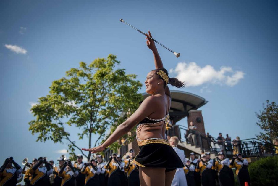 Freshman Simone Esters performs outside of Memorial Stadium during tailgating activities. Esters is the newest feature twirler for Marching Mizzou.