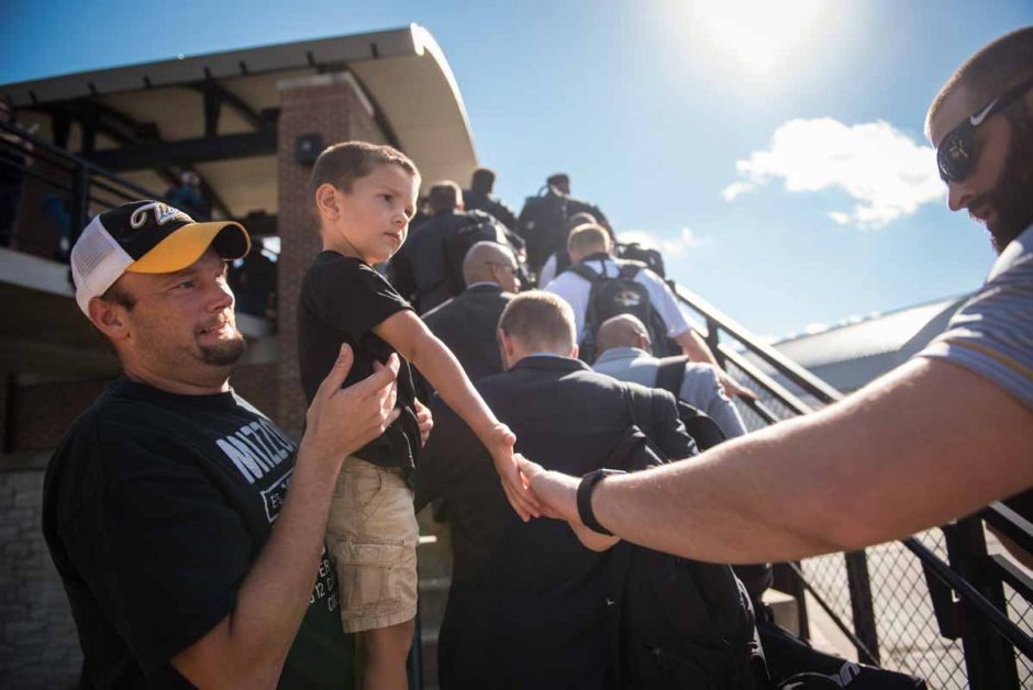 Carter Bexten, 2, and his father, Jeremy, show their support for the Mizzou Football team as they arrived to the stadium.