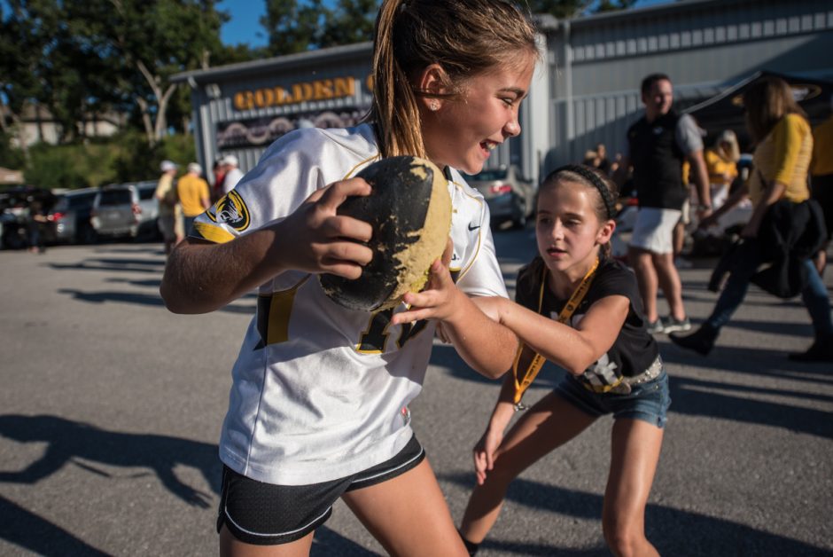 Ava Hughes, 9, plays against Sydney Schulte,9, in tailgating territory on Saturday.