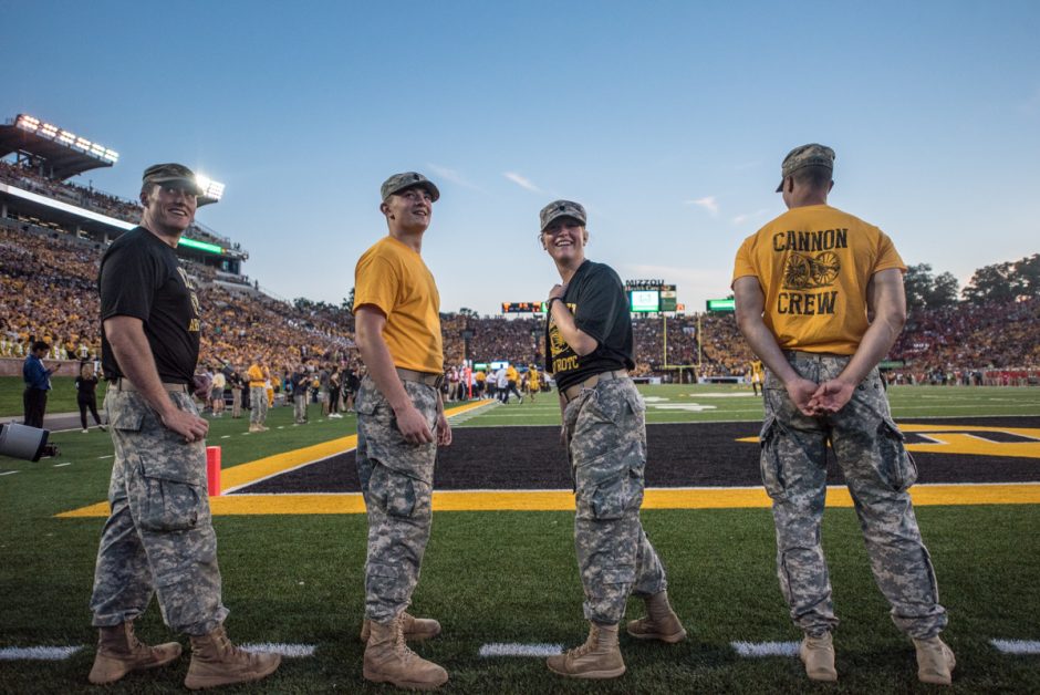 Mike Mizerny, Rob Dettmer, Becca Moss, and Jacob Thompson share a laugh as they look towards the jumbotron during a timeout at the Mizzou football game.