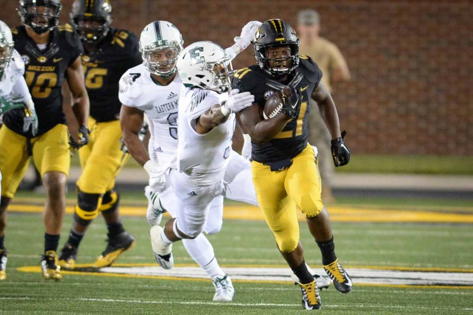 Junior running back Ish Witter escapes a tackle for a big Missouri gain. Witter rushed for a total of 61 yards with 13 carries.