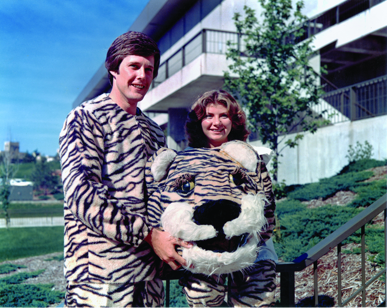 Debbie Snellen, BS Ed ’79, MA ’80, and Steve Wendling, BS Ag ’78, posed with their Big Tiger and Lil Tiger garb in front of the Hearnes Center. Photo courtesy of the Savitar. 