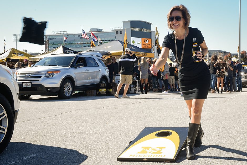Tamara Ferguson throws a bag of corn while playing a game of cornhole with fellow pre-game tailgaters. Photo by Shane Epping.
