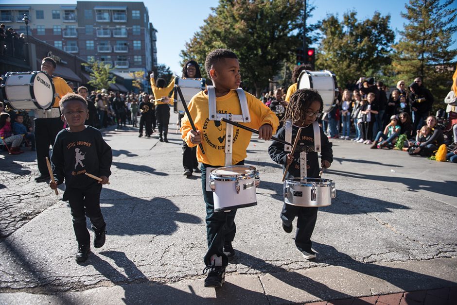 Children playing drums and marching.
