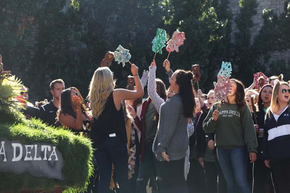 Kappa Delta sorority members cheer at the homecoming parade on Saturday, Oct. 22, 2016.