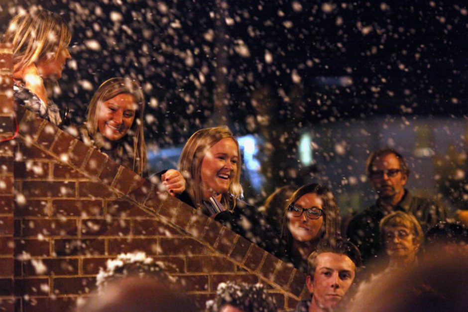 Chi Omega sorority member Emily Brown, middle, smiles as fake snow falls upon the crowd gathered to watch the skit put together by Chi Omega and Delta Chi that was based on their theme of The Grinch.