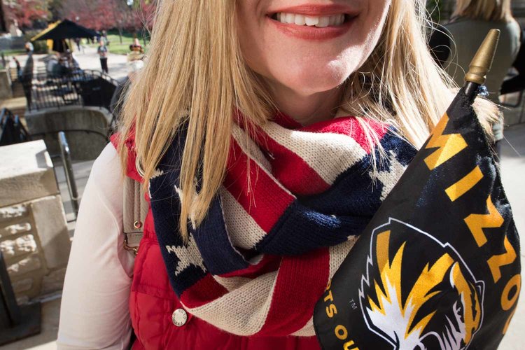 Woman with scarf bearing stars and stripes.