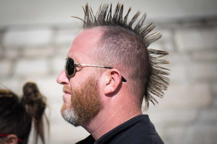 Man with mohawk and sunglasses.