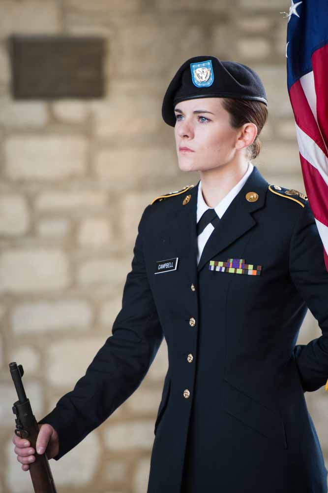 ROTC student in uniform standign at attention.