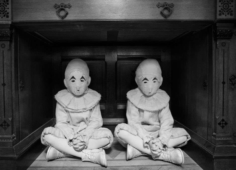 Twin children in white masks.