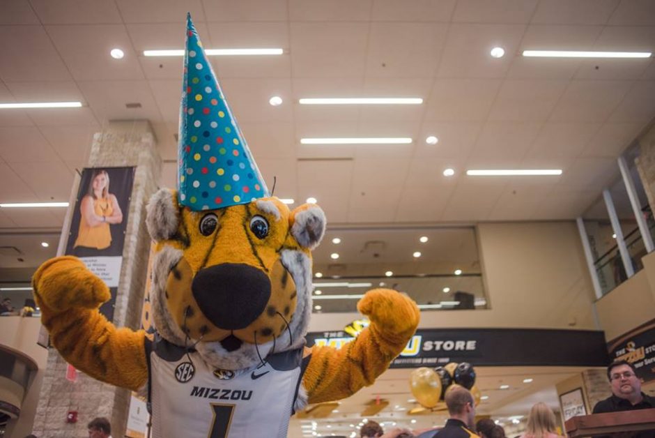 Truman the Tiger mascot in a party hat.