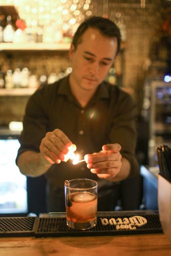 Bartender lighting a candle.