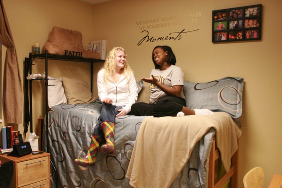Students sitting on a bed