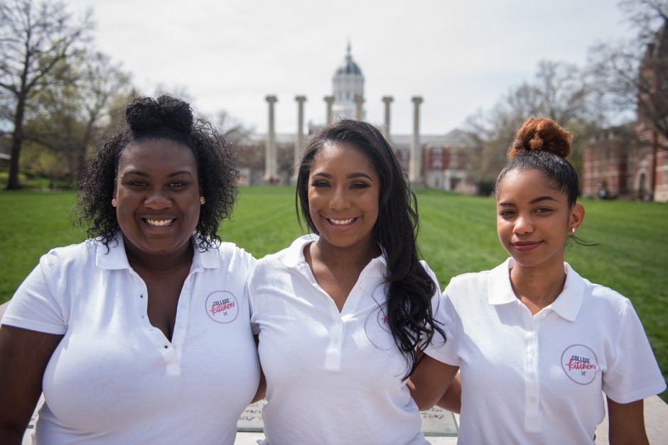Three students who founded College Kitchen standing in front of the Columns on Francis Quadrangle.
