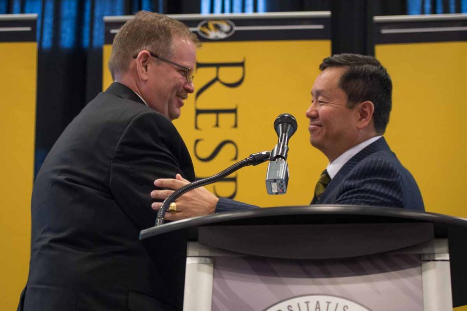 Chancellor Alex Cartwright and President Mun Choi share a handshake when Choi introduces him to speak.