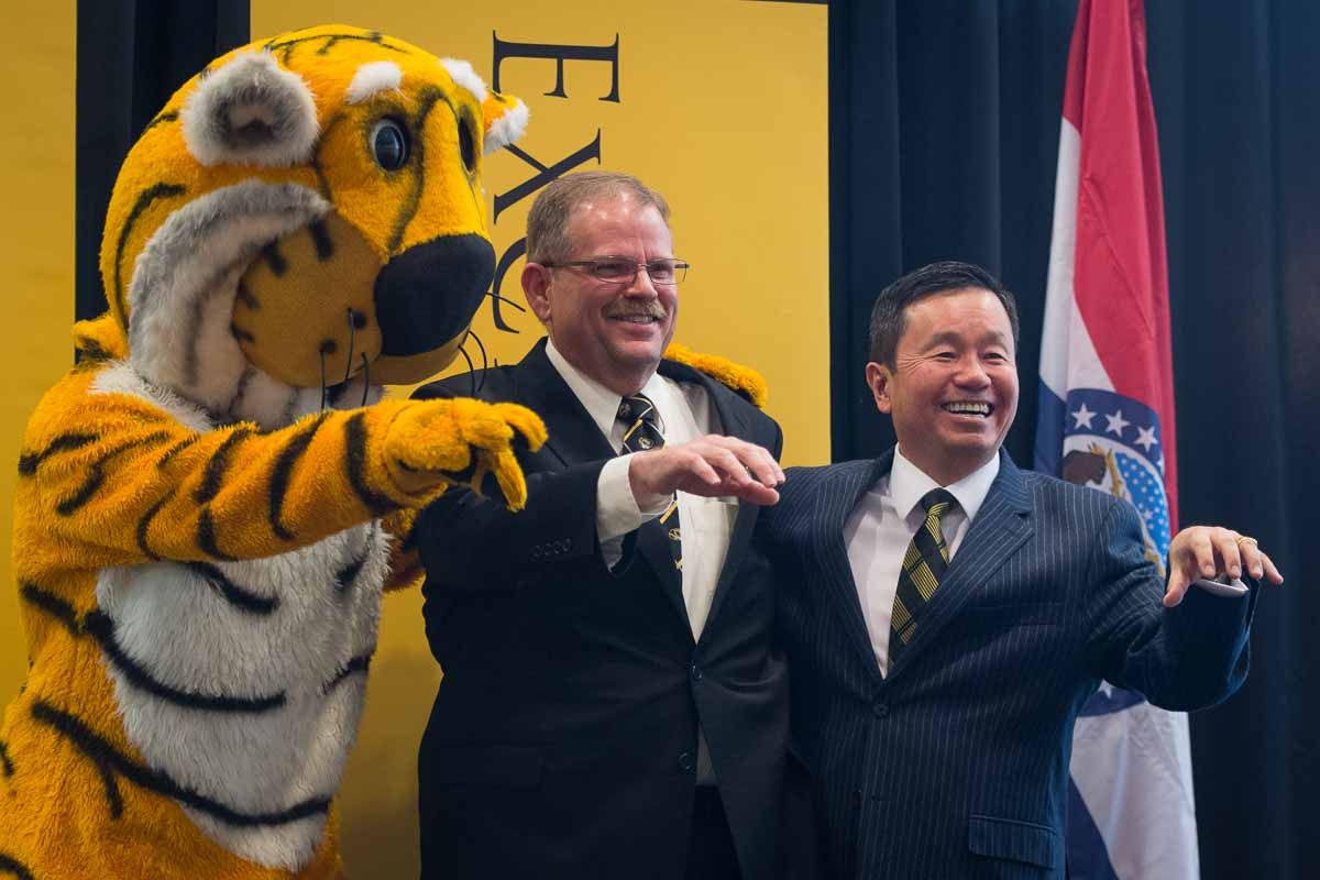 Truman, Chancellor Alex Cartwright, and President Mun Choi show off their "paws" at the end of the press conference where Cartwright was officially welcomed to the Mizzou community.