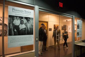 People standing outside the exhibit space for "Possum Town."