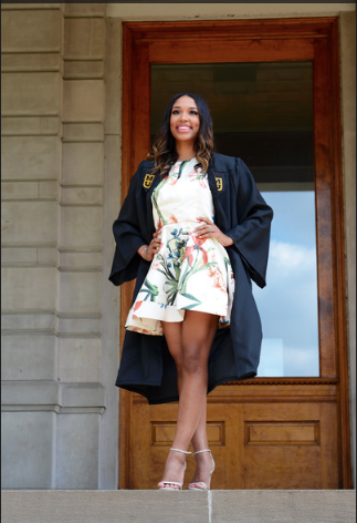 This is a picture of Chloe Cameron in her graduation robe in front of Jesse Hall 