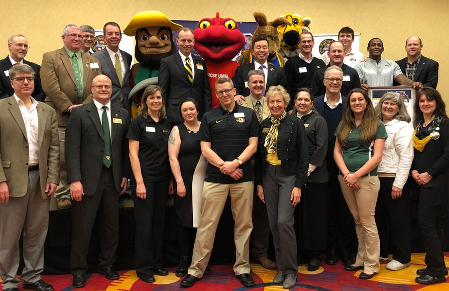 The Presidential Engagement Fellows represent all four campuses of the University of Missouri System. This is a picture of all the fellows with President Choi and the four mascots. 
