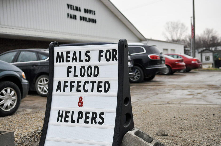 A sign outside the Velma Houts Fair Building in Holt County reads, "Meals for flood affected and helpers"