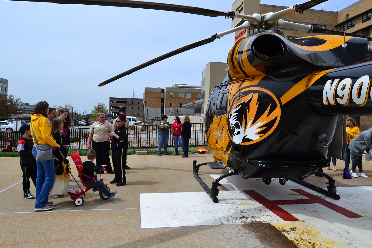 Families at Show Me Mizzou Day touring the helicopter