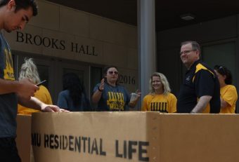Chancellor Alexander N. Cartwright volunteers to assist freshmen as they move into Brooks Hall at Mizzou.