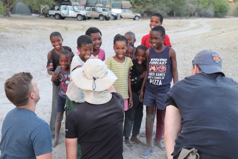 Picture of the cadets interacting with the children from the Botswanan tribe.