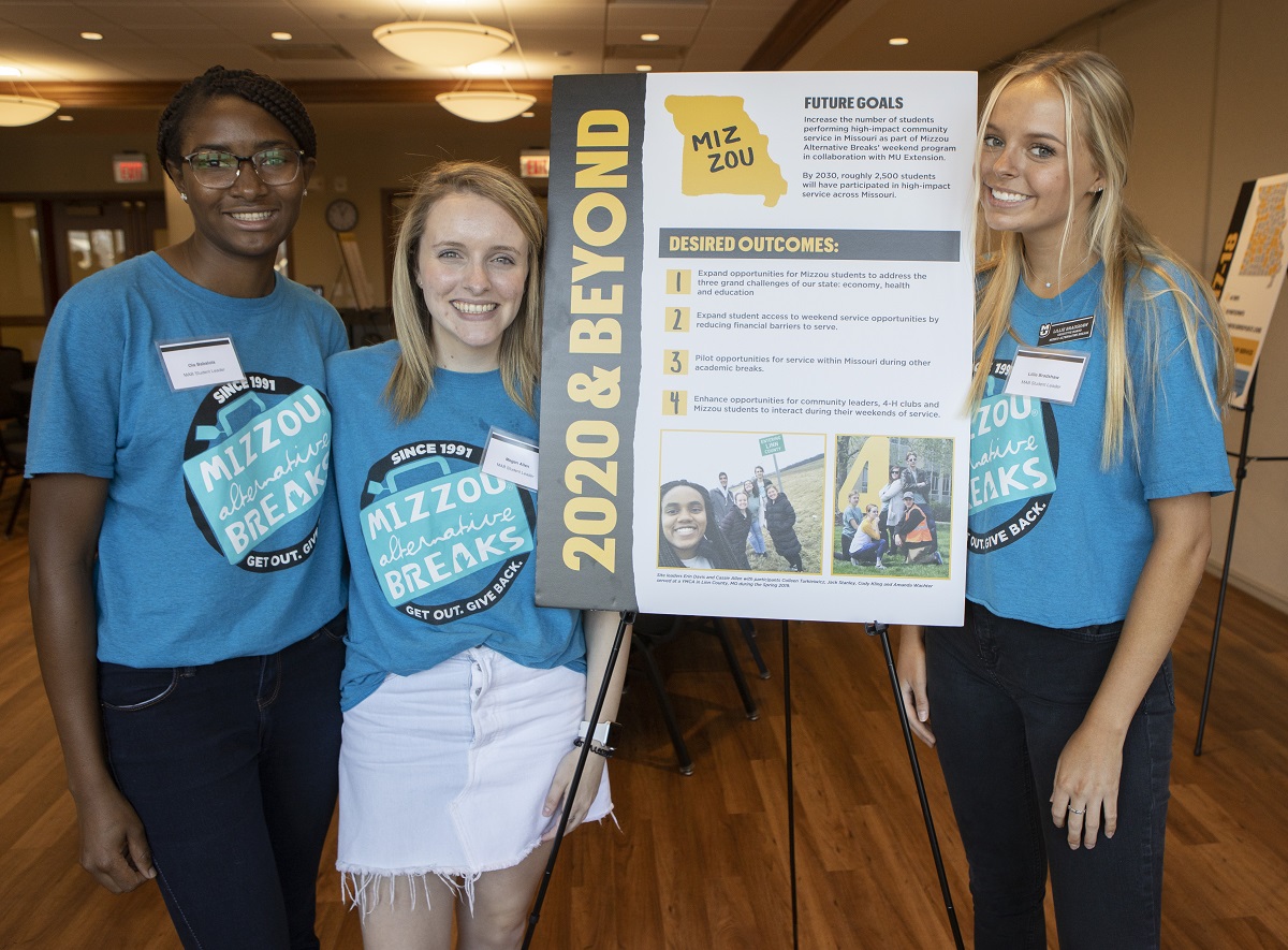 Mizzou Alternative Breaks student leaders post for a portrait with their future goals during the celebration of hitting their goal to serve all 114 Missouri counties one year ahead of schedule.