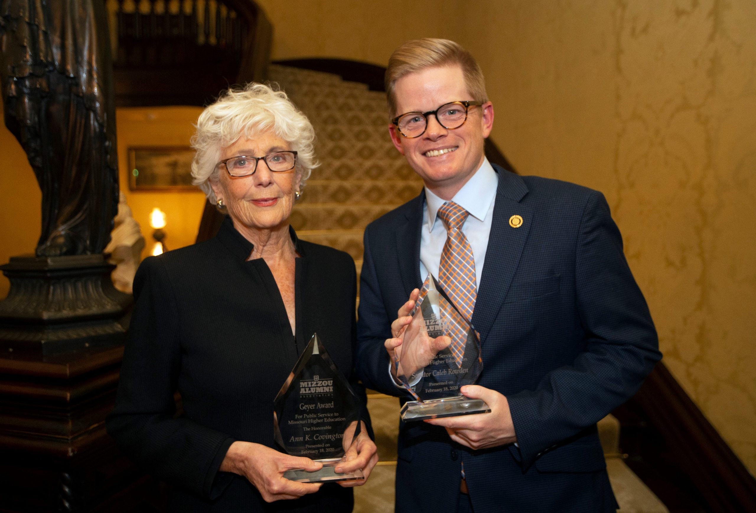 This is a picture of Ann Covington and Caleb Rowden posing wit their Geyer Awards at the Governor's Mansion. 