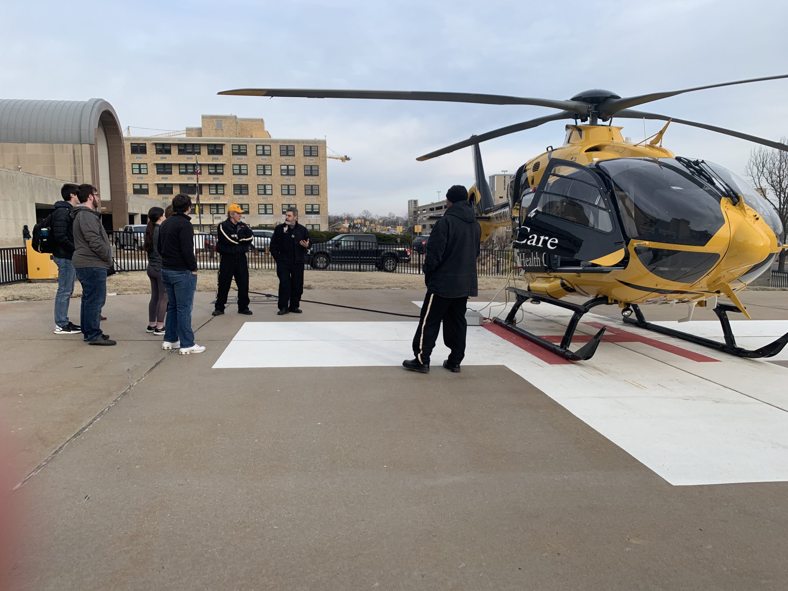 Students touring MU Health Care. This is a picutre of students learning about the ambulatory services as they stand next to the MU Health helicopter.
